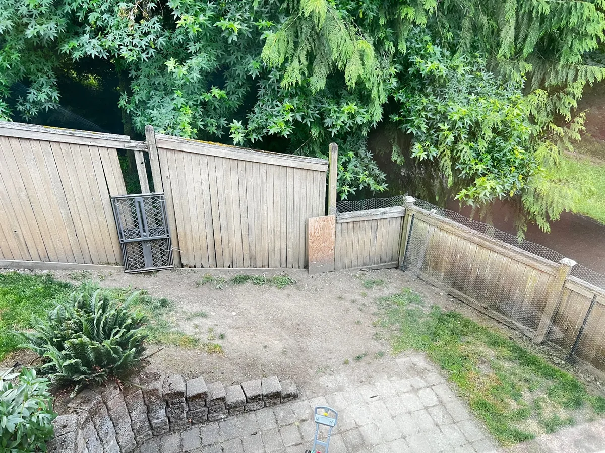 Weathered wood fence before renovation